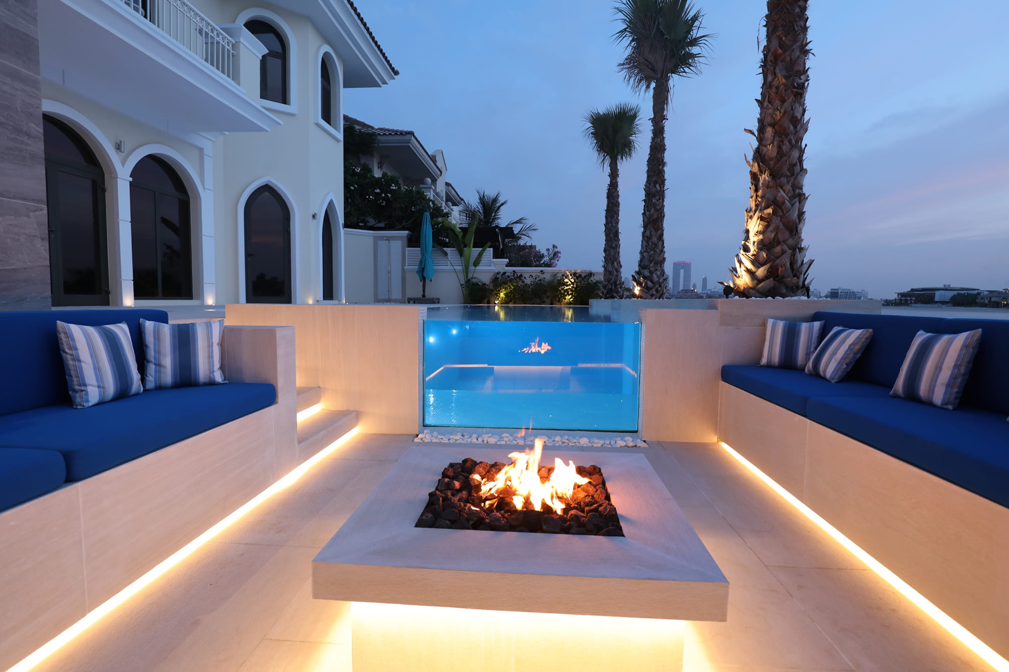 Glass Swimming Pool with Seating area and Fire Feature